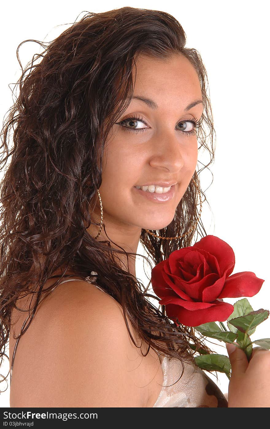 Lovely young teenager in a portrait shot with a red rose and curly hair, for white background. Lovely young teenager in a portrait shot with a red rose and curly hair, for white background.