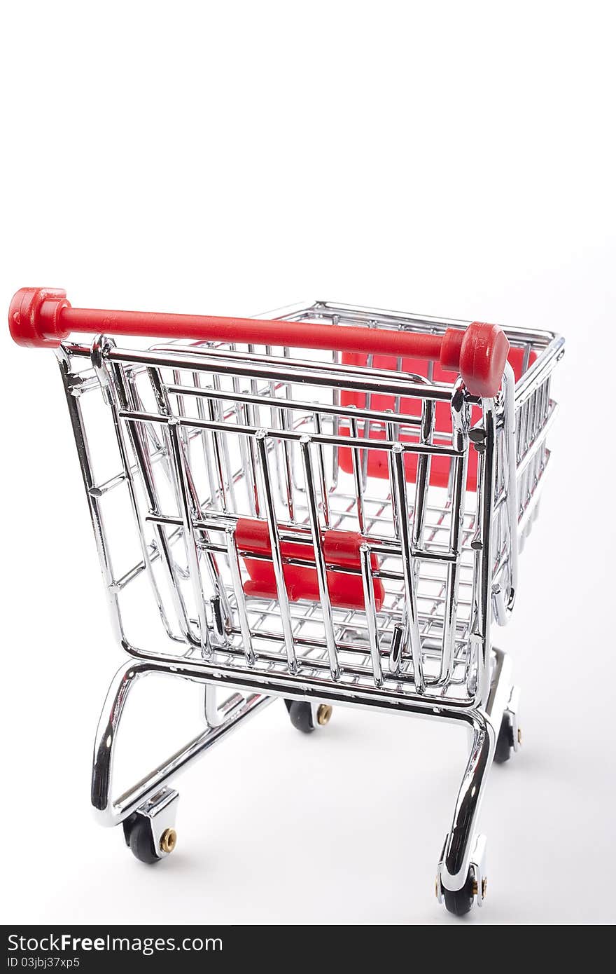 Empty shopping cart with the red handle on a white background.