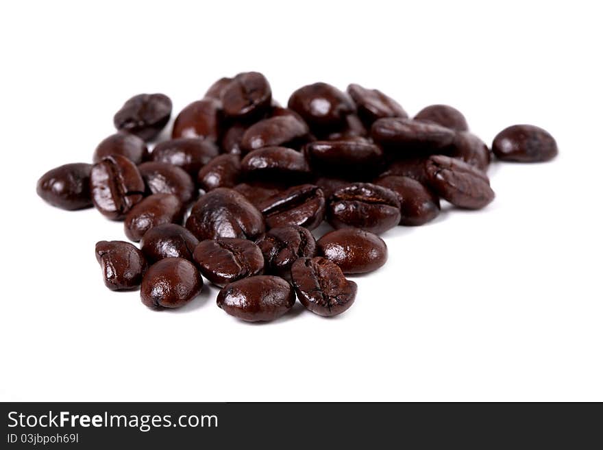 An arrangement of coffee beans on a white background