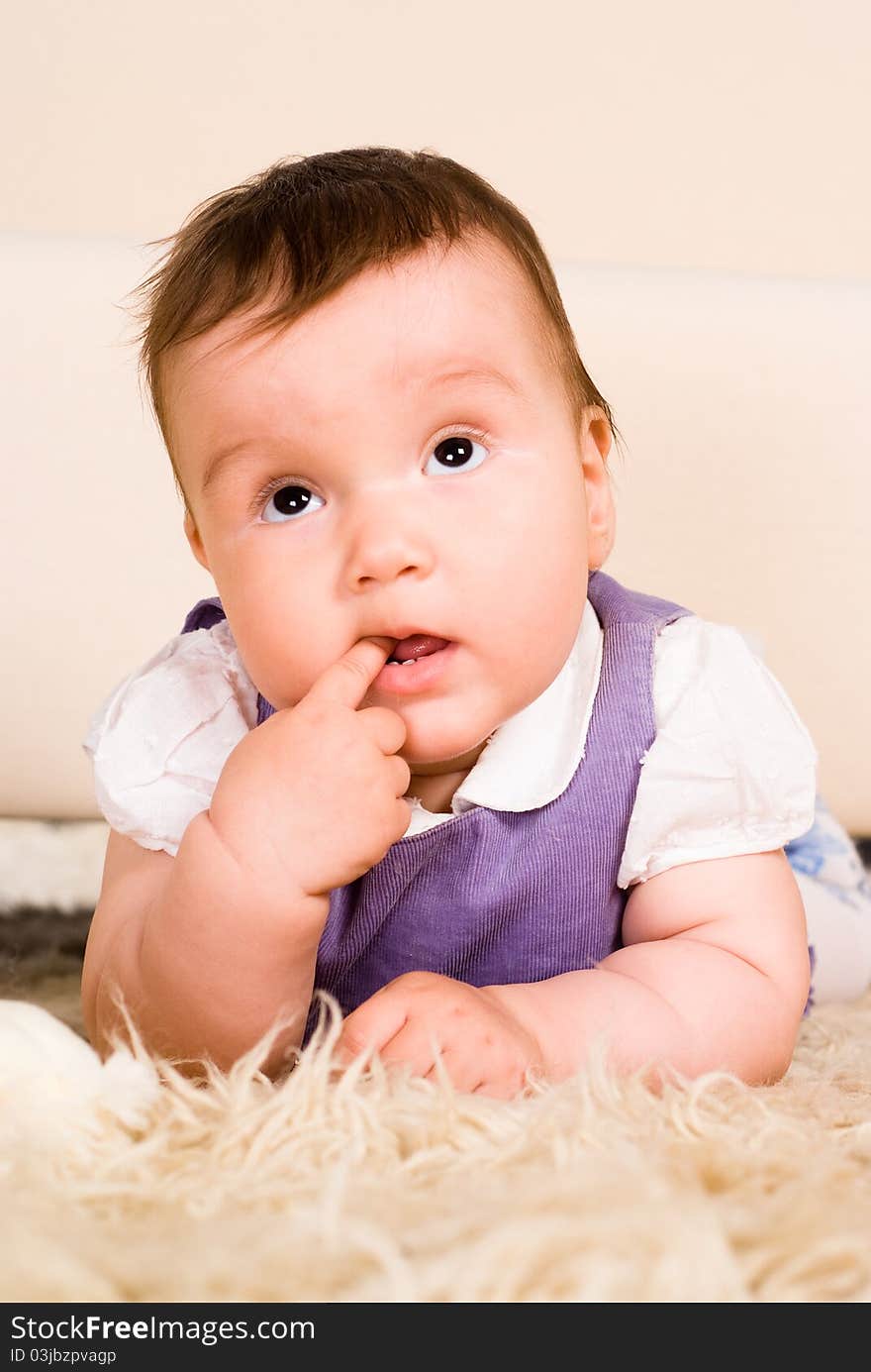 Portrait of a baby lying on a carpet. Portrait of a baby lying on a carpet