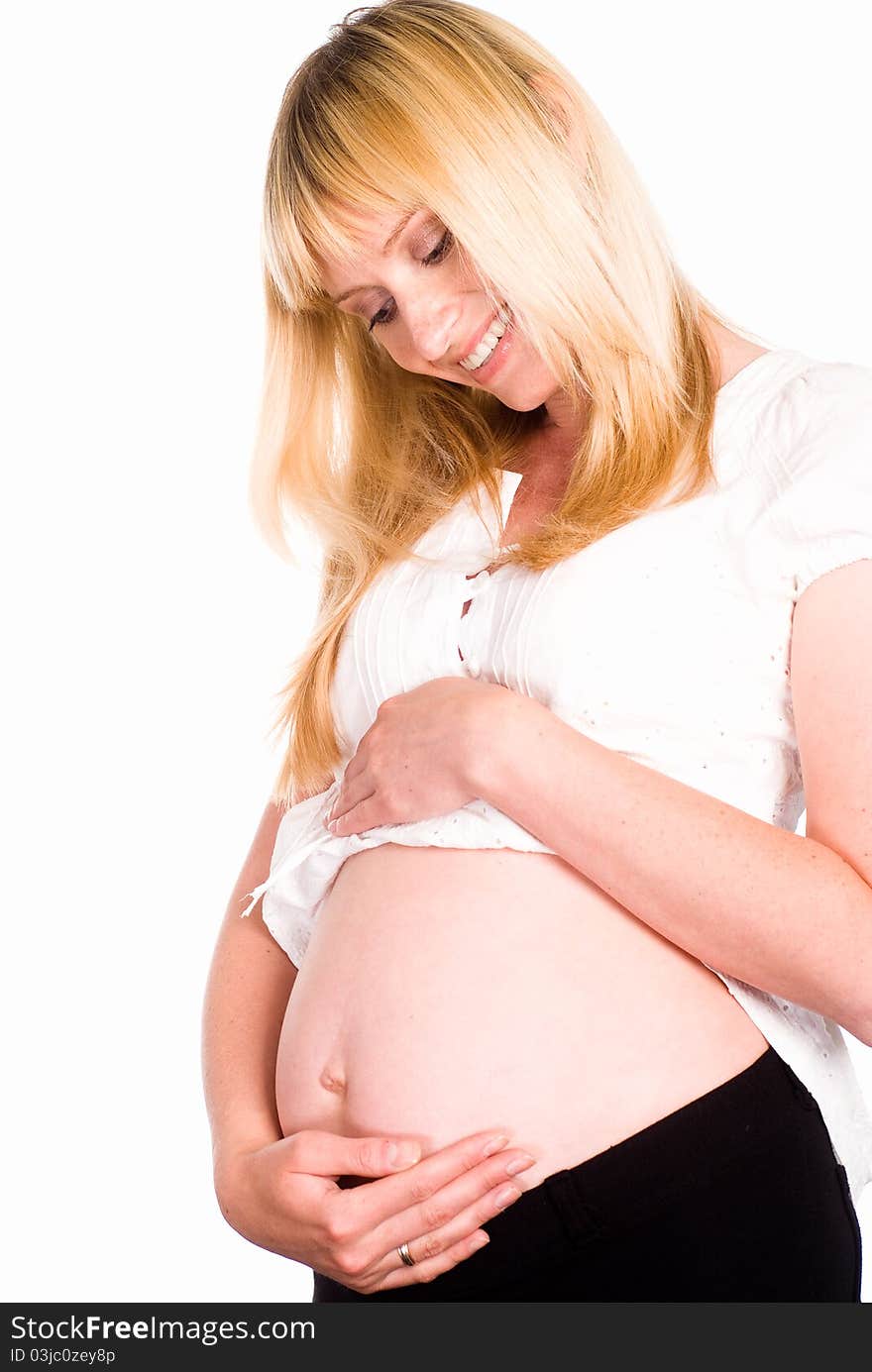 Pregnant woman in white standing on a white background