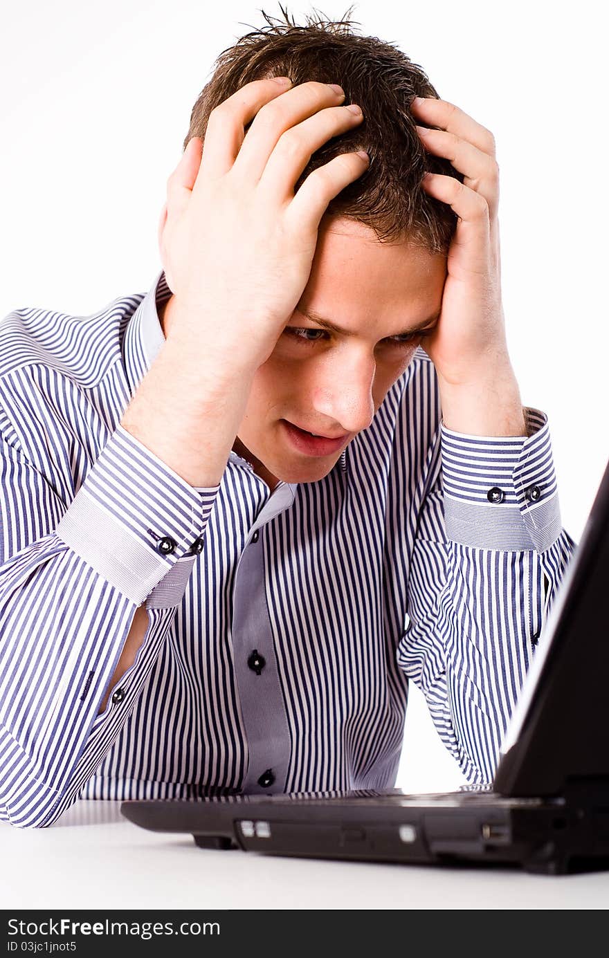 Young worker sitting at table with laptop. Young worker sitting at table with laptop