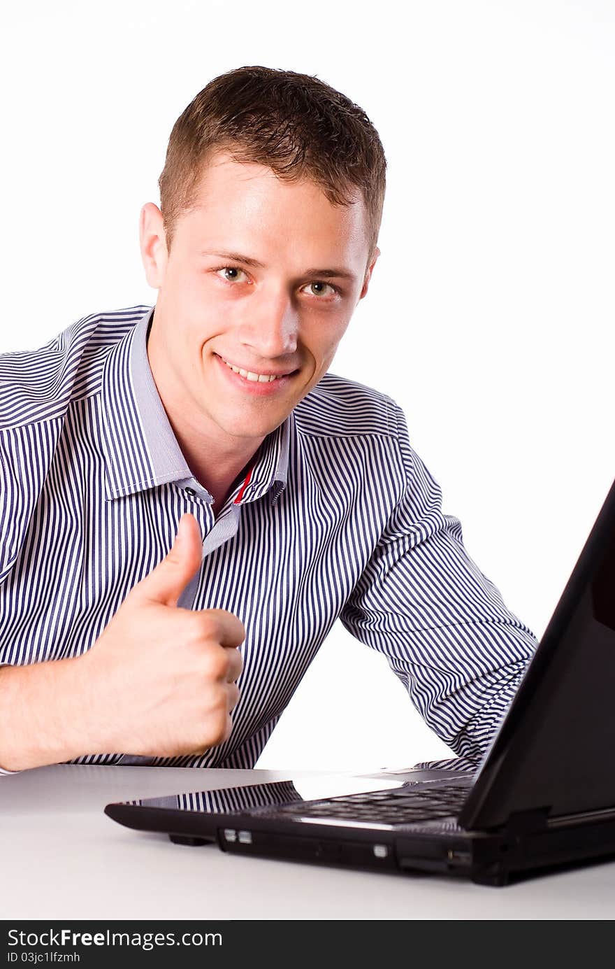 Young worker sitting at table with laptop. Young worker sitting at table with laptop