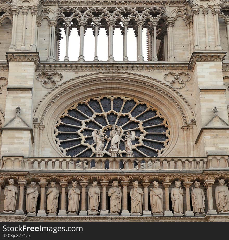 Notre Dame of Paris: Virgin and kid over large rose and gallery of kings under the balustrade of the main facade. Notre Dame of Paris: Virgin and kid over large rose and gallery of kings under the balustrade of the main facade