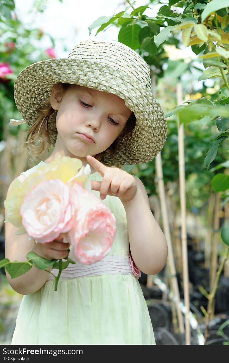 An image of a little girl with big roses