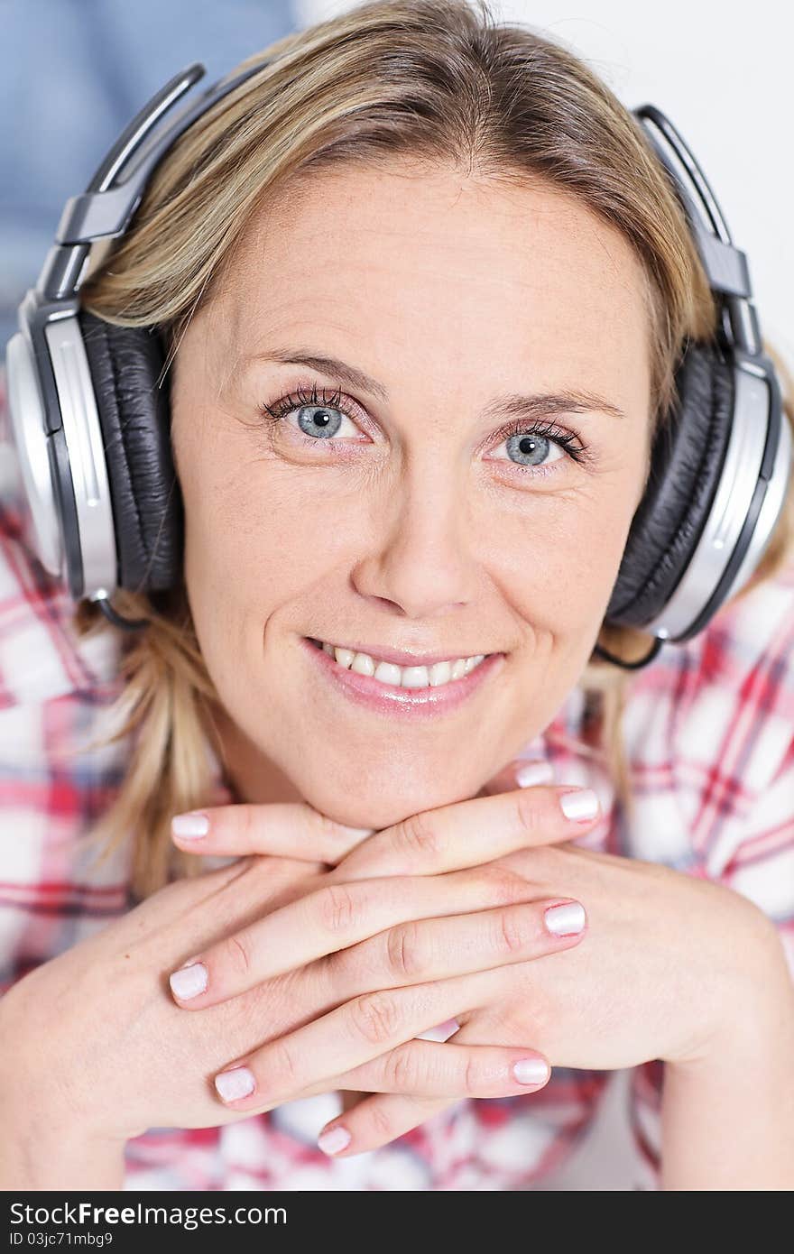 Beautiful blond womanlistening music with headphones. Beautiful blond womanlistening music with headphones