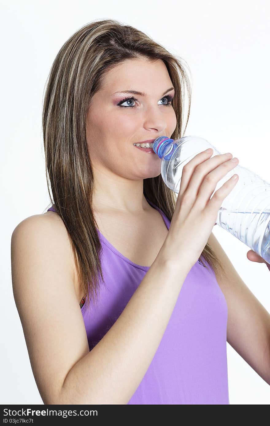 Beautiful blond woman drinking water after sport