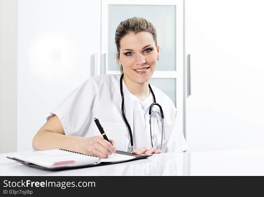 Woman doctor with pen and stethoscope in hospital. Woman doctor with pen and stethoscope in hospital