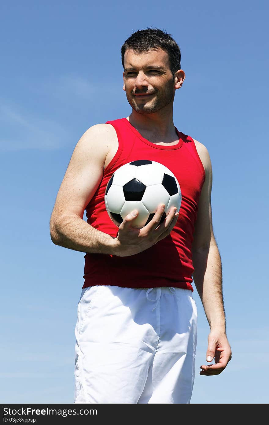 Man with ball and blue sky in summer