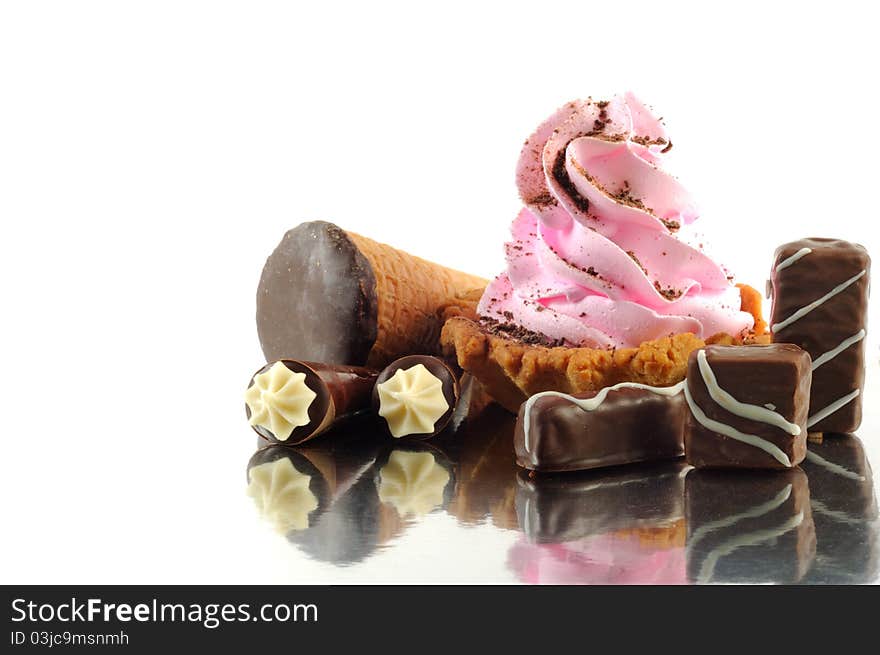 Chocolate sweets and cupcake, isolated on a white background