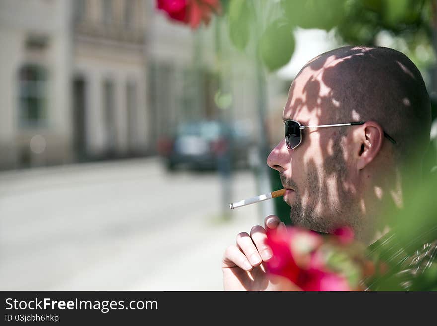 Young man with cigarette in mouth. Young man with cigarette in mouth