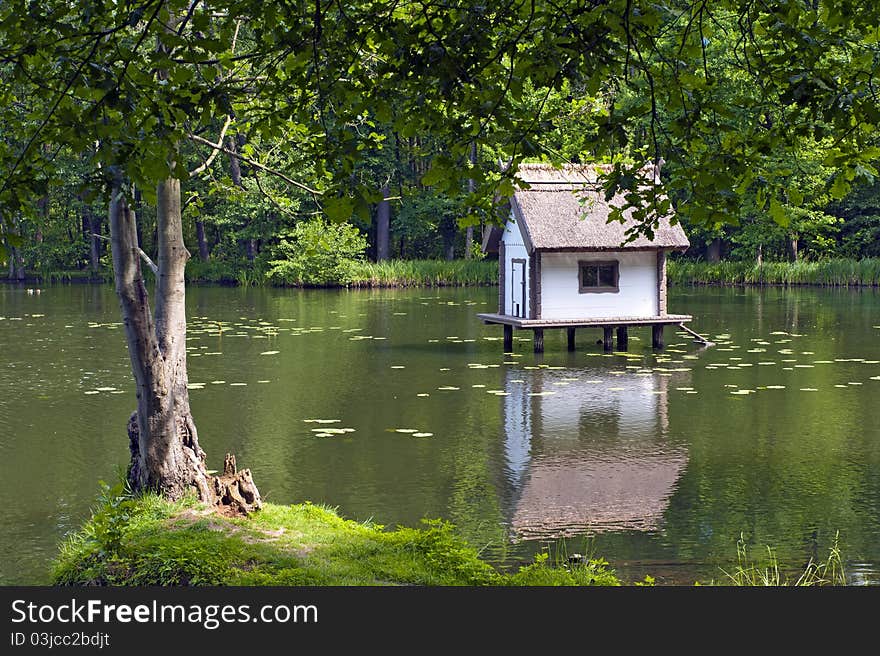 Duck house on a lake in a park. Duck house on a lake in a park