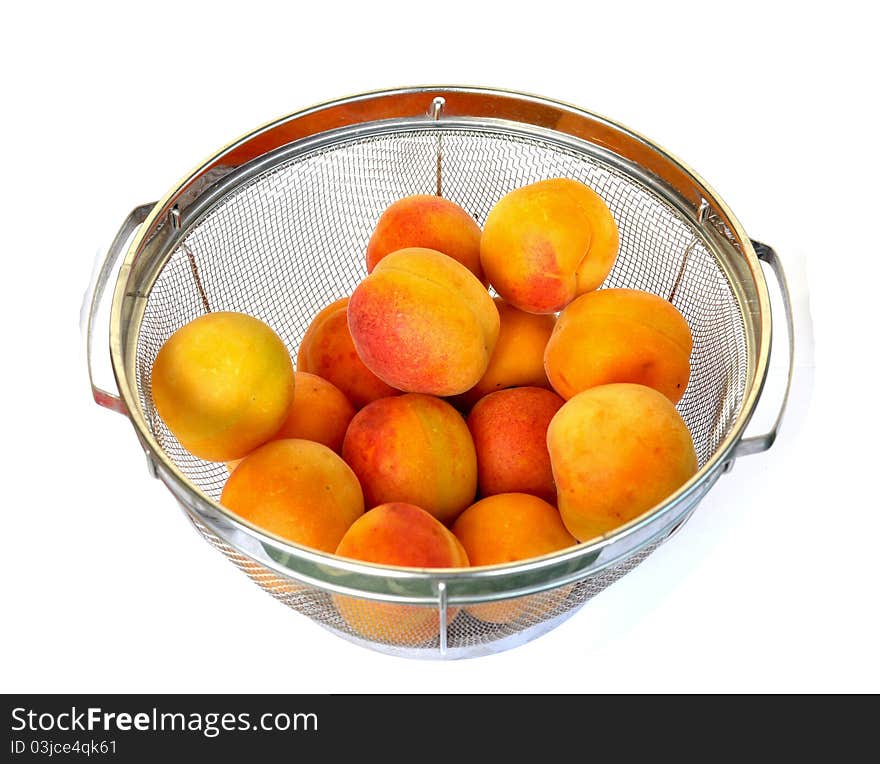 Apricots in a strainer ready to be rinsed with water. Apricots in a strainer ready to be rinsed with water