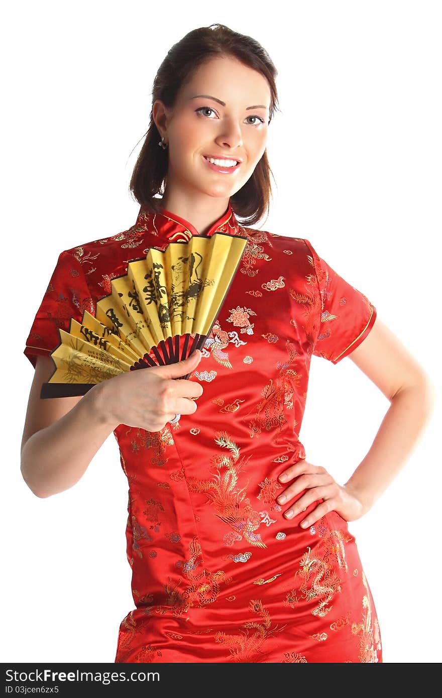 The young and beautiful girl in a traditional red Chinese dress with a yellow fan. The young and beautiful girl in a traditional red Chinese dress with a yellow fan