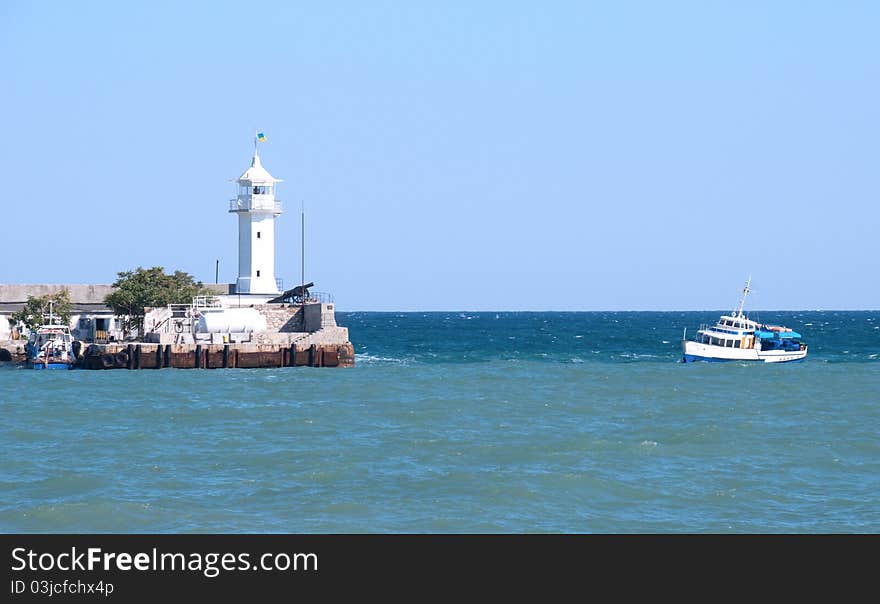 Small beacon  and a boat in the sea