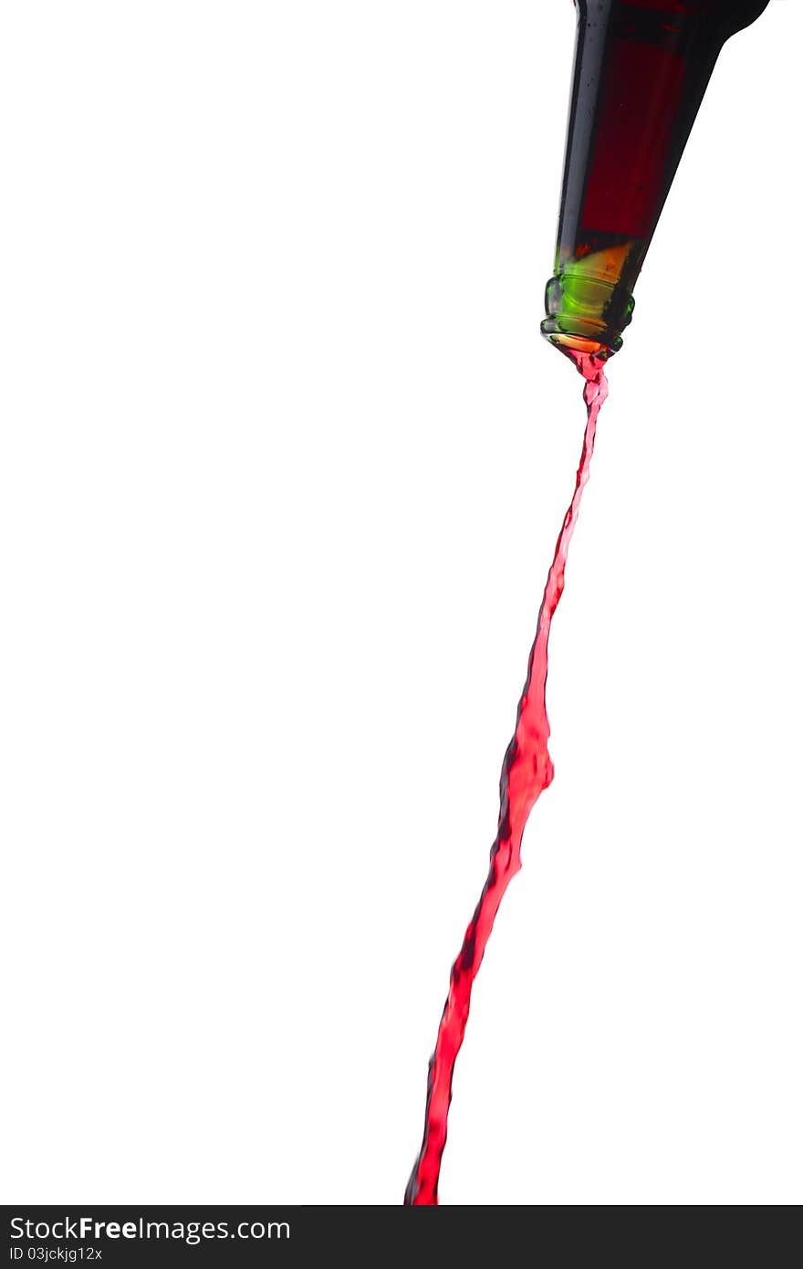 Splashing red water from bottle, isolated over white background.