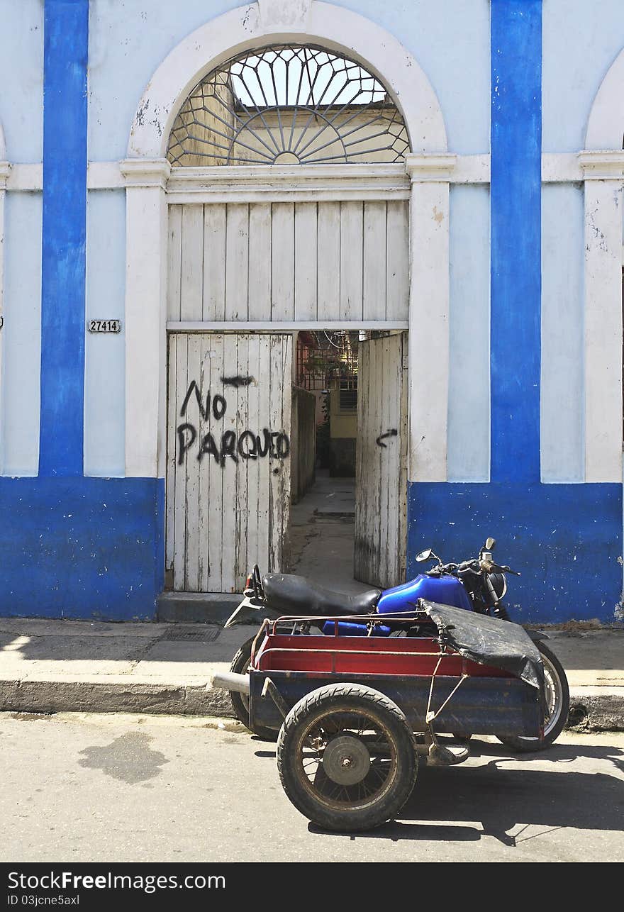 Old Motorbike In Front Of Door