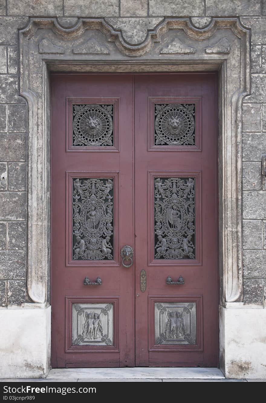 Old wooden door with metal decorations in historical house. Old wooden door with metal decorations in historical house