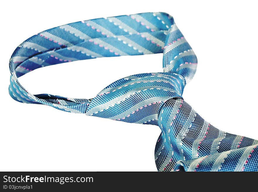 Closeup knot of blue silk necktie isolated over white background