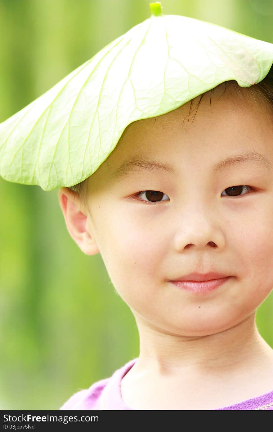 Asian boy with leaf cap