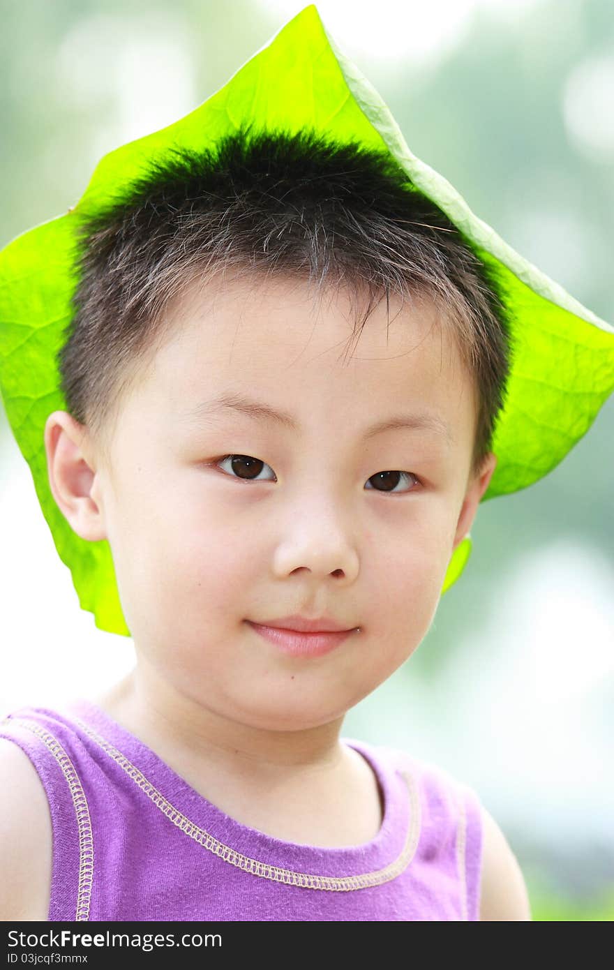 Asian boy with leaf cap