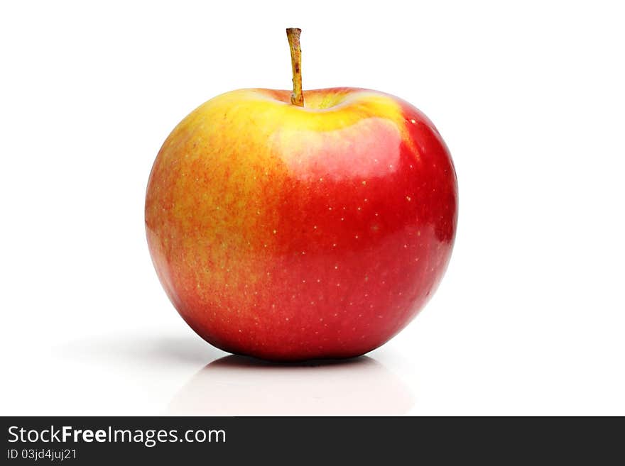 Red apple on the polished surface, isolated on a white background in studio. Red apple on the polished surface, isolated on a white background in studio.