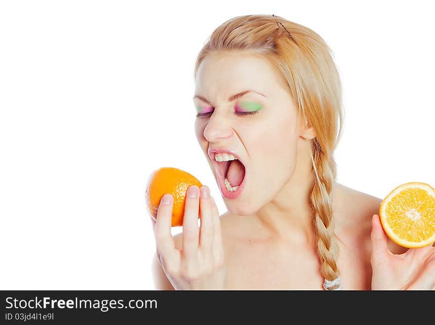 Young woman yells at oranges in her hands. Young woman yells at oranges in her hands