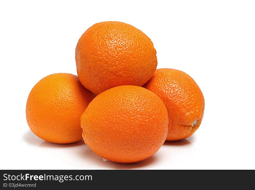 Oranges on a polished surface, isolated on a white background in studio. Oranges on a polished surface, isolated on a white background in studio.