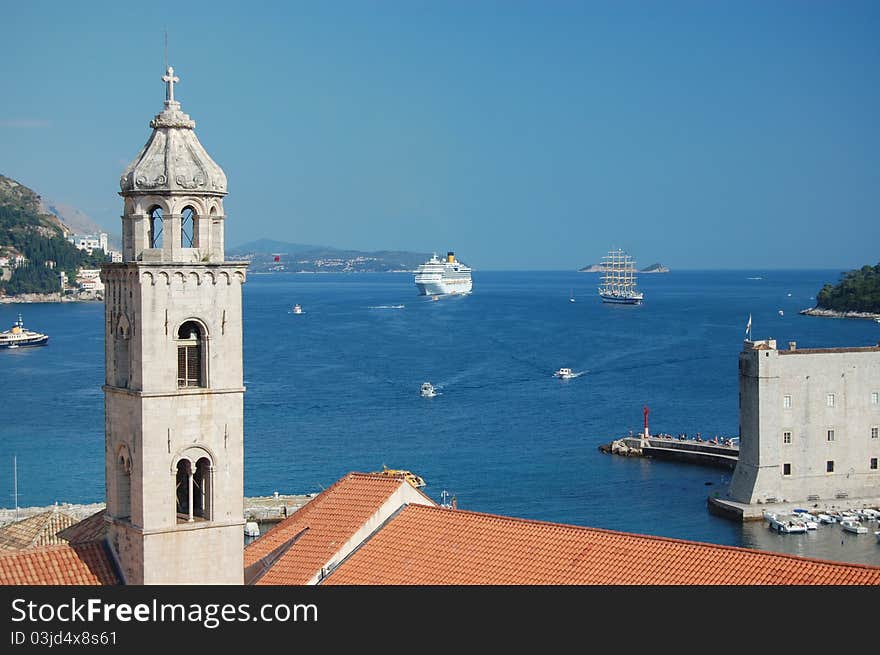 A photograph of a cruise liner and a sailboat outside the ancient city of Dubrovnik in Croatia. A photograph of a cruise liner and a sailboat outside the ancient city of Dubrovnik in Croatia