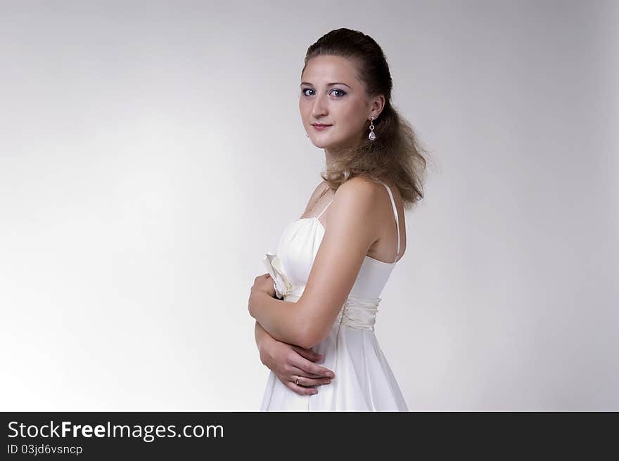 Portrait of a  young beautiful woman on a gray background closeup. Portrait of a  young beautiful woman on a gray background closeup