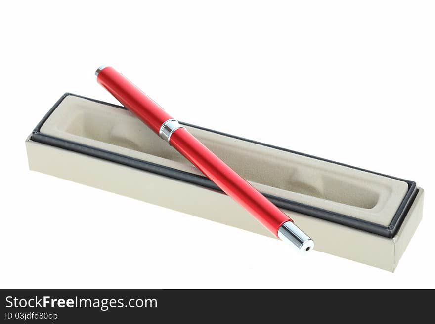 Red pen lays on a box that opens the lid and white background