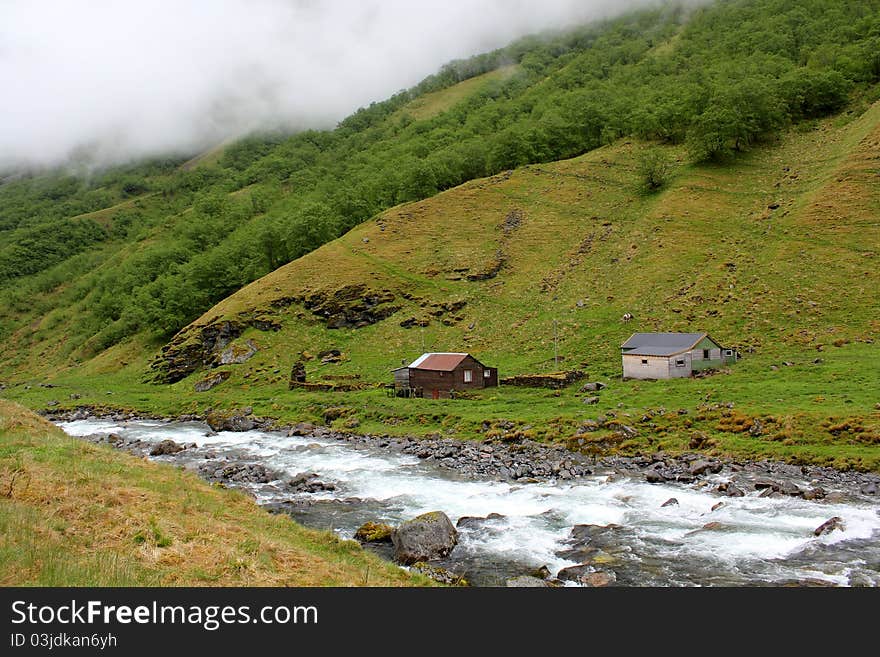 Landscape with mountain, river and houses near Undredal, Western Norway. Landscape with mountain, river and houses near Undredal, Western Norway.