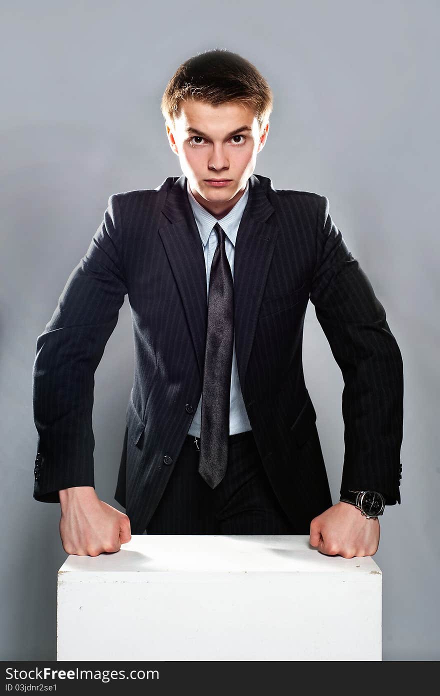 Young and seriously businessman stand