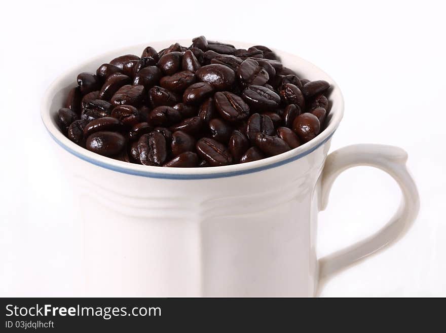 An arrangement of coffee beans on a white background