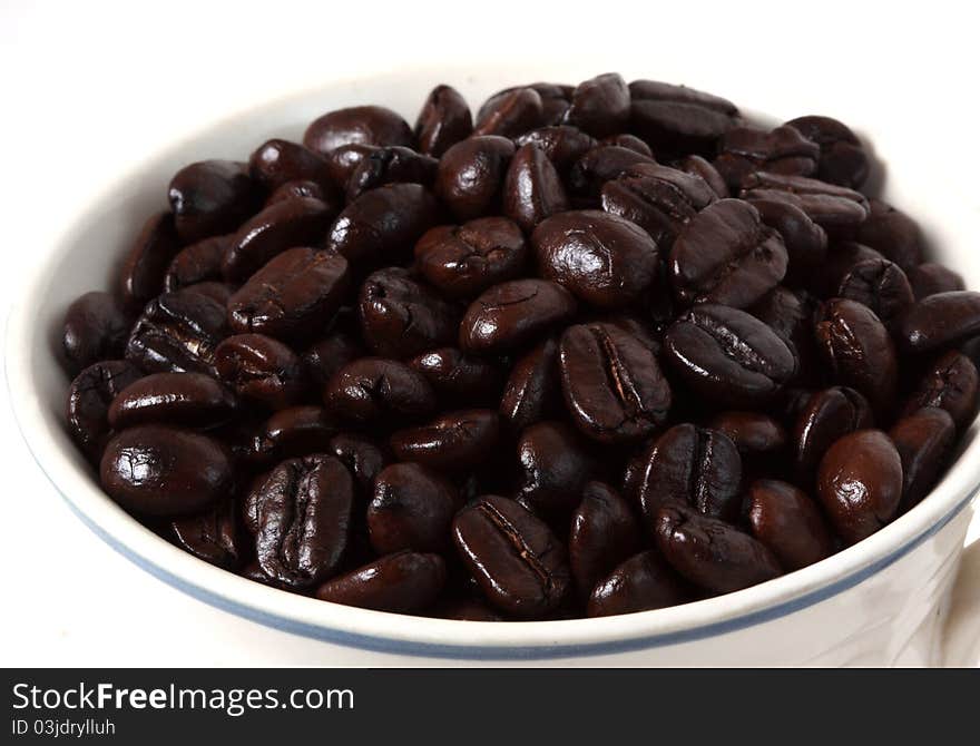 An arrangement of coffee beans on a white background