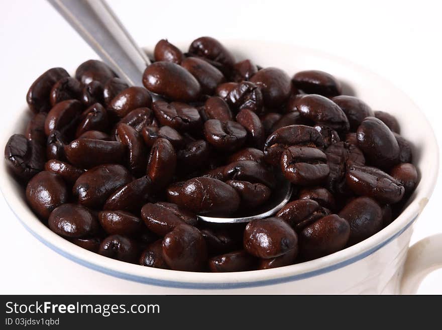 An arrangement of coffee beans on a white background