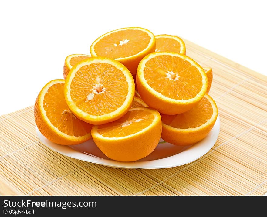 Oranges cut in half lying on a plate