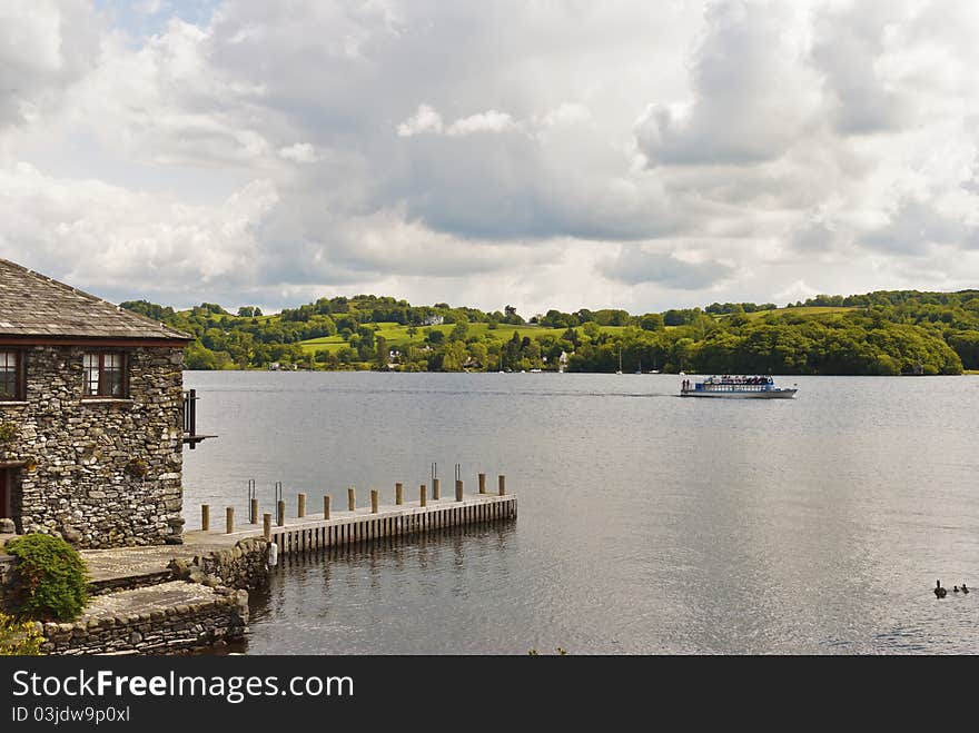 A stone built house on the edge of a lake. A stone built house on the edge of a lake