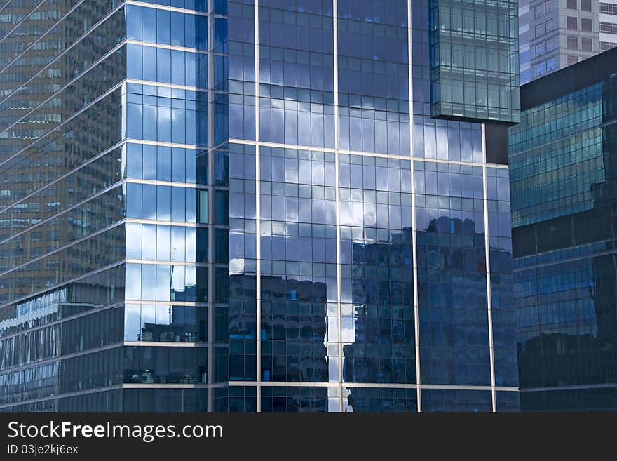 An office building in Melbourne, Australia reflects a cloudy sky and neighboring structures. An office building in Melbourne, Australia reflects a cloudy sky and neighboring structures