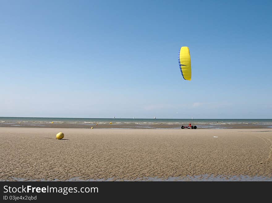 Kite and car which is like sand-yachting but it is faster with a kite and the wheels are bigger. Kite and car which is like sand-yachting but it is faster with a kite and the wheels are bigger