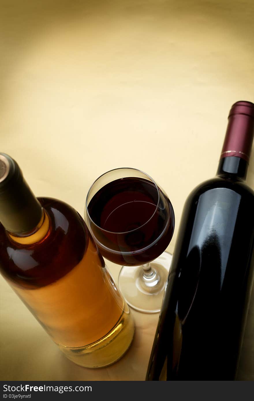 Bottle and glass of wine on a dark background