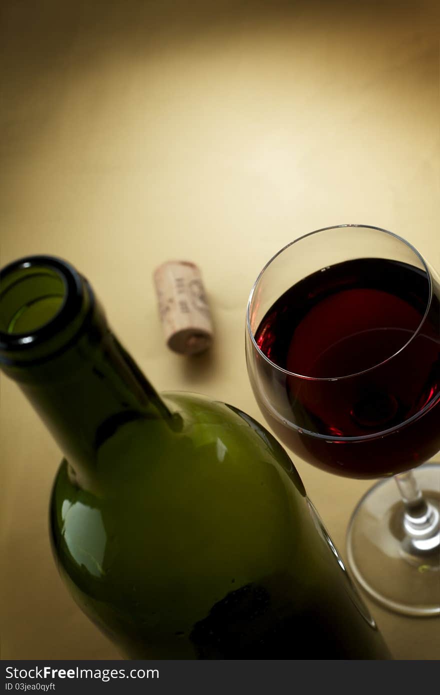 Bottle and glass of wine on a dark background