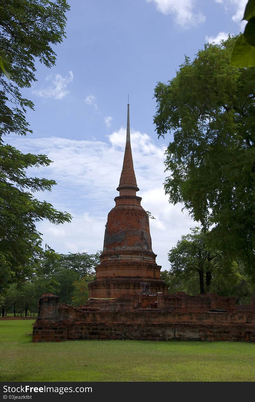 Damaged pagoda is located within the park. Ayutthaya, Thailand. Damaged pagoda is located within the park. Ayutthaya, Thailand