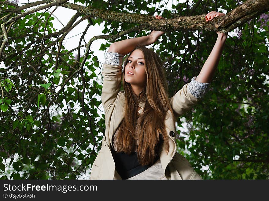 A beautiful girl hanging on a tree