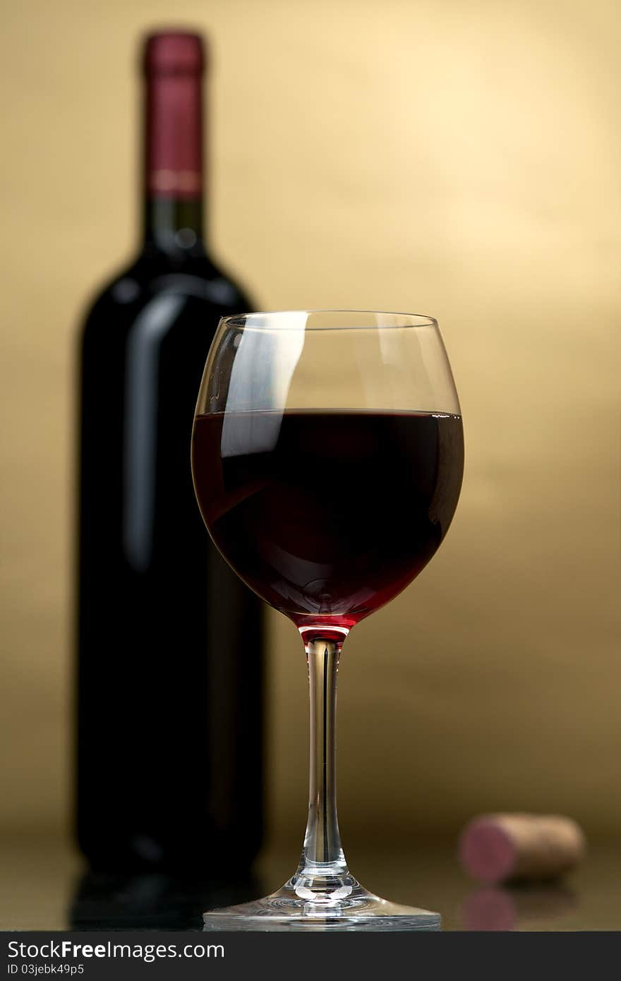 Bottle and glass of wine on a dark background. Bottle and glass of wine on a dark background