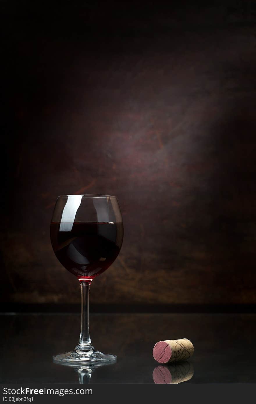 Glass of red wine on a dark background. Glass of red wine on a dark background