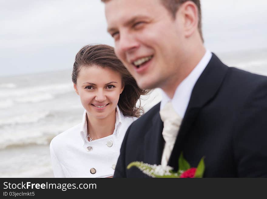 Young wedding couple kissing at the street.