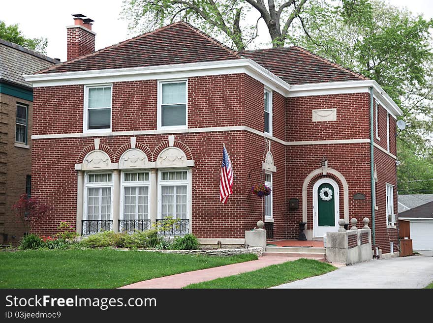 Image of brick house with nice landscaping.