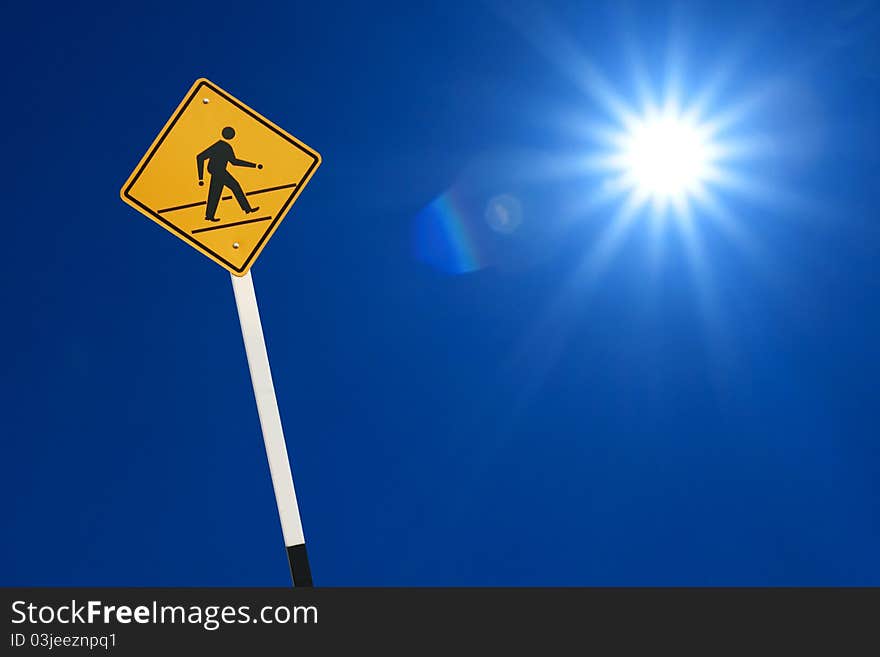 Yellow walk sign with blue sky