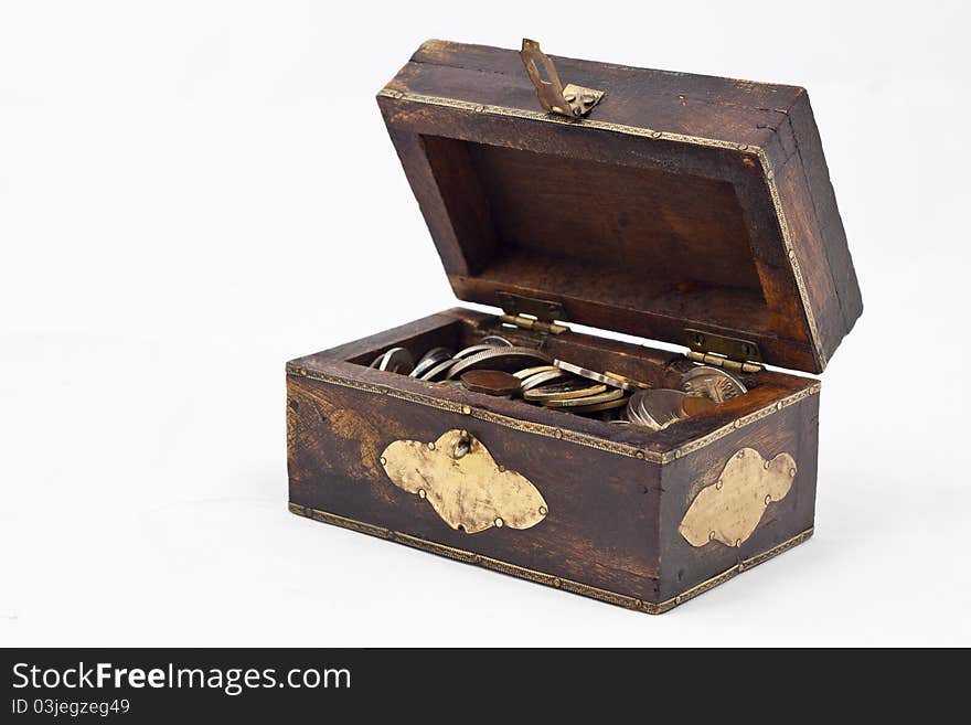 A small wooden chest full of coins. A small wooden chest full of coins